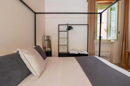 a bedroom with a large white bed with a window at B&B Palazzo Vittoria in Bisceglie