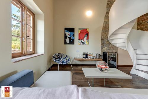 a living room with a staircase and a table at Chianti B&B Design infinity pool shared in Pianella