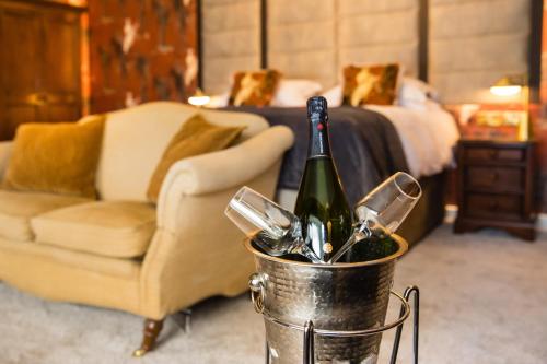 a bucket with a bottle of champagne and a couch at The Burgoyne in Reeth