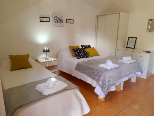 a bedroom with two beds and a mirror at Cabañas Puertas del Sol in La Rioja