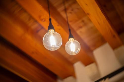 three light bulbs hanging from a wooden ceiling at B&B Palazzo Vittoria in Bisceglie