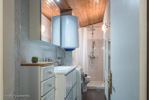 een badkamer met een wastafel en een blauwe kast bij Arieli Apartments Izola in Izola