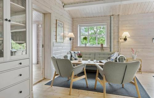 a living room with a table and chairs at Gorgeous Home In Asnæs With Kitchen in Asnæs