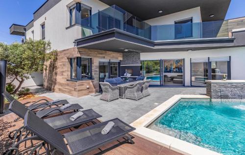 a house with a swimming pool and a patio at Stunning Home In Pula in Pula
