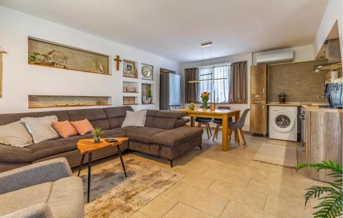 a living room with a couch and a table at 1 Bedroom Amazing Home In Skatari in Škatari
