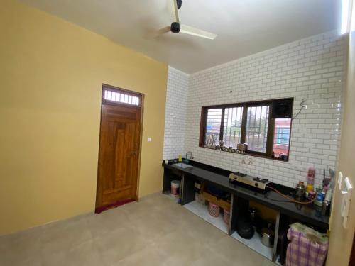 a room with a counter and a window and a ceiling fan at Utsav villas in Dapoli