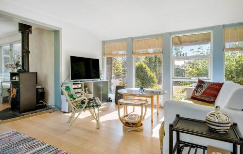 a living room with a couch and a table at 3 Bedroom Beautiful Home In Nykøbing Sj in Nyrup