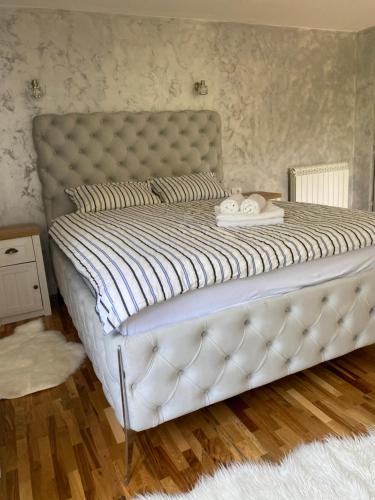 a bed in a bedroom with a white mattress at Apartman17 in Belgrade