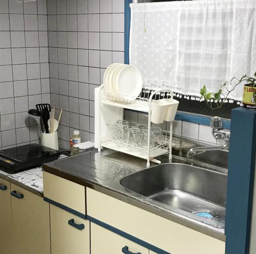 a kitchen with a sink and a counter top at Rosemary 201 in Kagoshima
