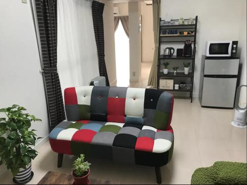 a living room with a couch in a room at Rosemary 201 in Kagoshima