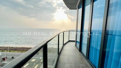 a view of the ocean from the balcony of a building at M8 Ocean King Three Bed Apartment in Cinnamon Gardens
