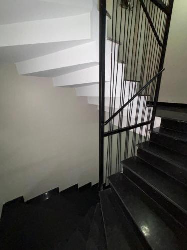 a stairway with black steps and a white wall at Moon Hostel in Istanbul