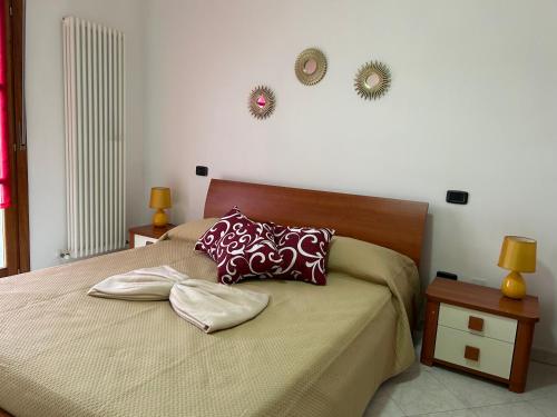 a bedroom with a bed with two pillows on it at Sesta Terra in Aulla