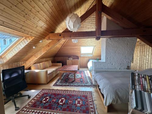 a attic room with a bed and a couch at Villa Laura in Lausanne