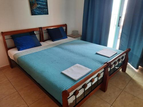 a bed with blue sheets and blue pillows in a bedroom at Holiday Apartment with Sea View (0002913) in Paralimni