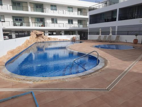 a large swimming pool in the middle of a building at Holiday Apartment with Sea View (0002913) in Paralimni