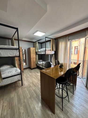 a room with bunk beds and a table and chairs at Moon Hostel in Istanbul