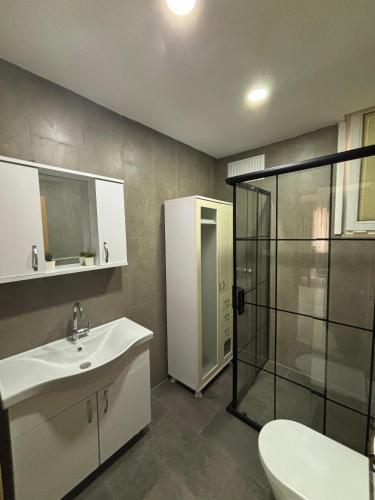 a bathroom with a sink and a glass shower at Moon Hostel in Istanbul