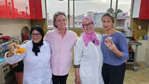 a group of four women standing in a kitchen at Riad Atrium & Spa in Marrakech