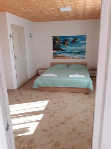 a bedroom with a bed and a painting on the wall at Casa Ștefania in Pescari