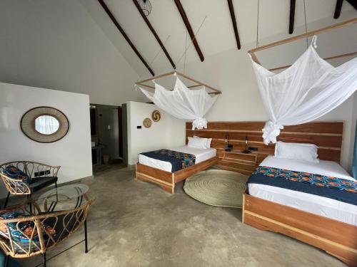 Tanzania Safari Lodge في أروشا: غرفة نوم بسريرين وطاولة