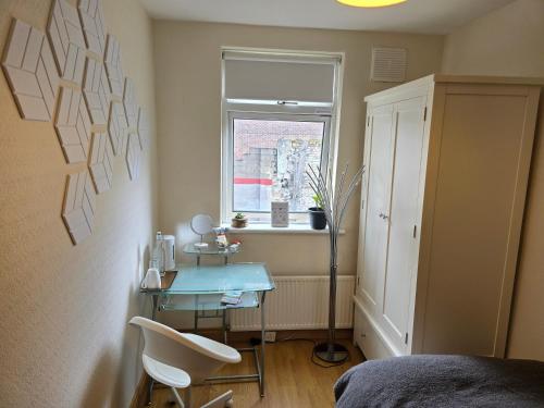 a small room with a table and a window at City Nest. in Dublin