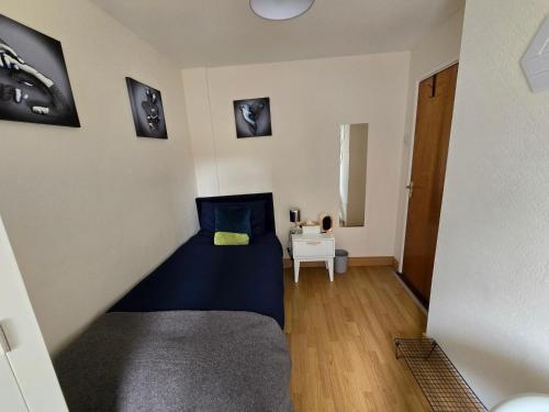 a small bedroom with a bed and a table at City Nest. in Dublin