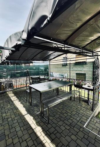 a table and benches under an umbrella on a patio at Mansarda Spadone in Musso