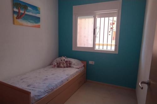 a small bedroom with a bed and a window at Las mejores vistas de Oropesa in El Borseral