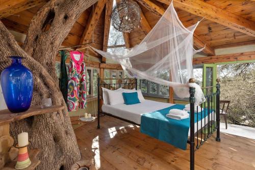 a bedroom with a bed in a tree house at Margaritis's Treehouse in Paramonas