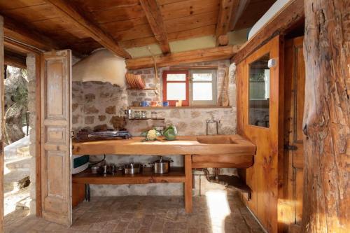 a kitchen with a sink in a wooden house at Margaritis's Treehouse in Paramonas