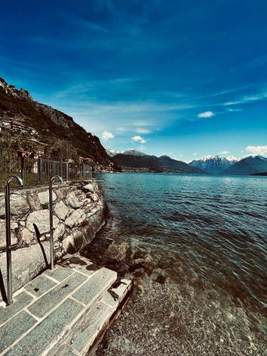 a view of a body of water with mountains at Mansarda Spadone in Musso