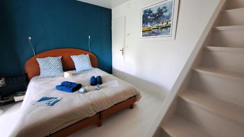 a small bedroom with a bed with blue accents at CHAMBRE PRIVEE AVEC SALON, garage voiture, vélos, motos in Tourville-sur-Arques