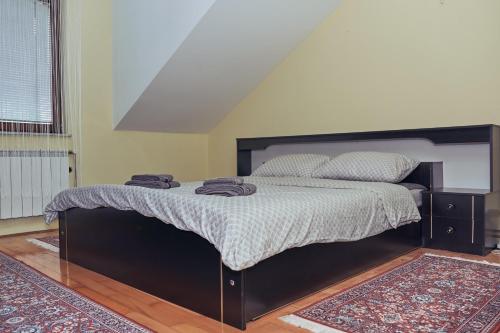 a bedroom with a bed with two towels on it at Nanki's Residence in Visoko