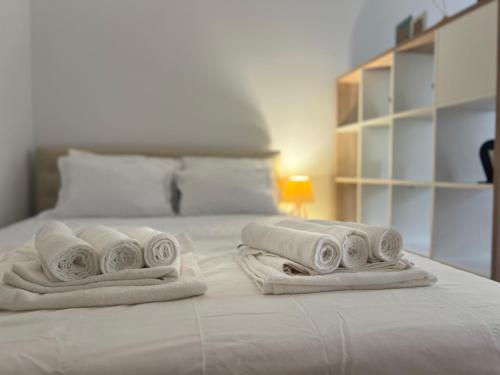 a pile of towels sitting on top of a bed at River Apartment in Banja Luka