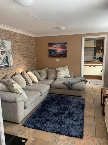 a living room with a couch and a brick wall at Kings Lynn 1 in Kings Lynn