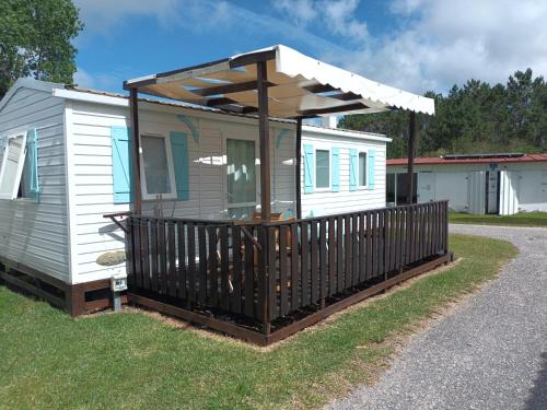 a tiny house with a porch with a roof at Slow M'Ocean Villa in Pataias