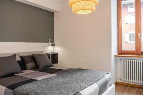 a bedroom with a large bed in a room at Le finestre sul Duomo in Trento