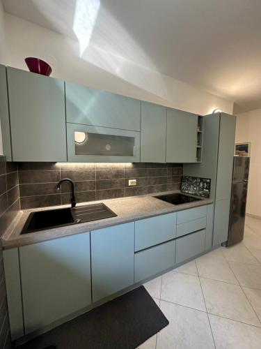 a kitchen with white cabinets and a sink at Apartments Zlatko & Mira Dorcic in Baška