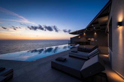 a view of the ocean from the balcony of a house at Aeliades Villas in Agios Nikitas