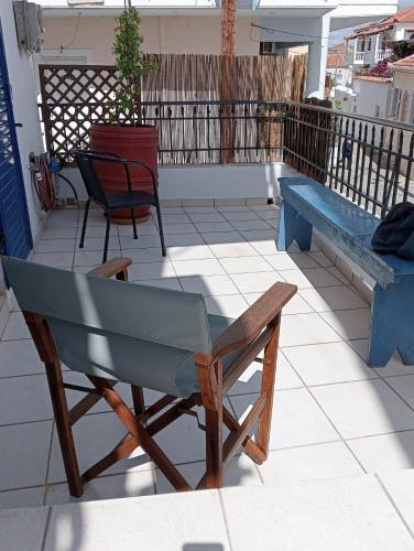 a chair and a bench on a patio at LimonoSpito in Koroni