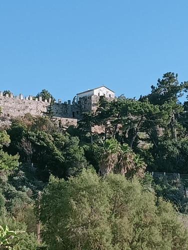 a castle on top of a hill with trees at LimonoSpito in Koroni