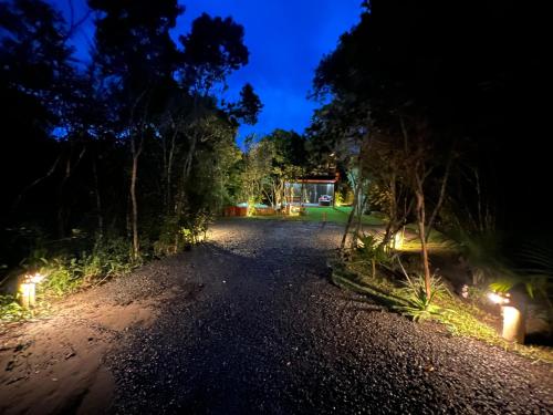 a driveway at night with lights on the side at Casa.dovale3 in Caeté-Açu