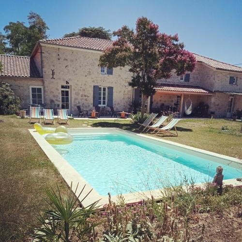 une grande piscine devant une maison dans l'établissement Gîte Roméo le clos st jean, à Saint-Jean-de-Thurac