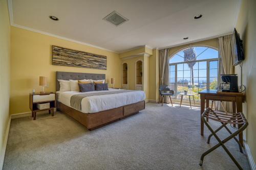 a bedroom with a large bed and a large window at Casa Asturias in Ensenada