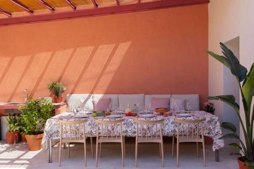 a table with chairs and a table cloth on it at La Casa del Mar in Valencia