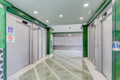 a corridor with green and white walls and doors at 14th floor Sea View in Adeje