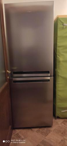 a stainless steel refrigerator in a kitchen at Cintoia, Tuscany Beautiful villa with private pool in Santa Luce