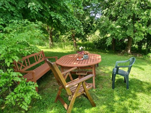 a wooden table and chairs next to a wooden bench at Dom pod Galazka in Bochnia