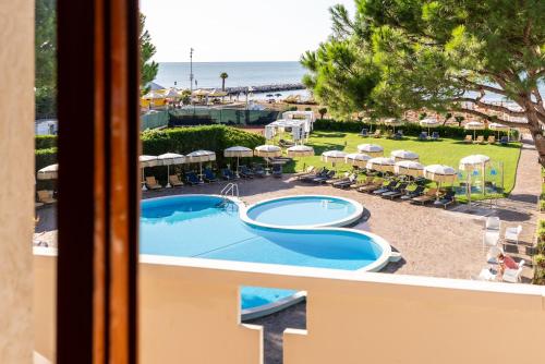a view of a swimming pool from a balcony of a resort at Hotel Negresco in Lido di Jesolo